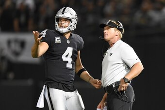 OAKLAND, CA - SEPTEMBER 10:  Derek Carr #4 of the Oakland Raiders speaks with head coach Jon Gruden in the first quarter during their NFL game against the Los Angeles Rams at Oakland-Alameda County Coliseum on September 10, 2018 in Oakland, California.  (