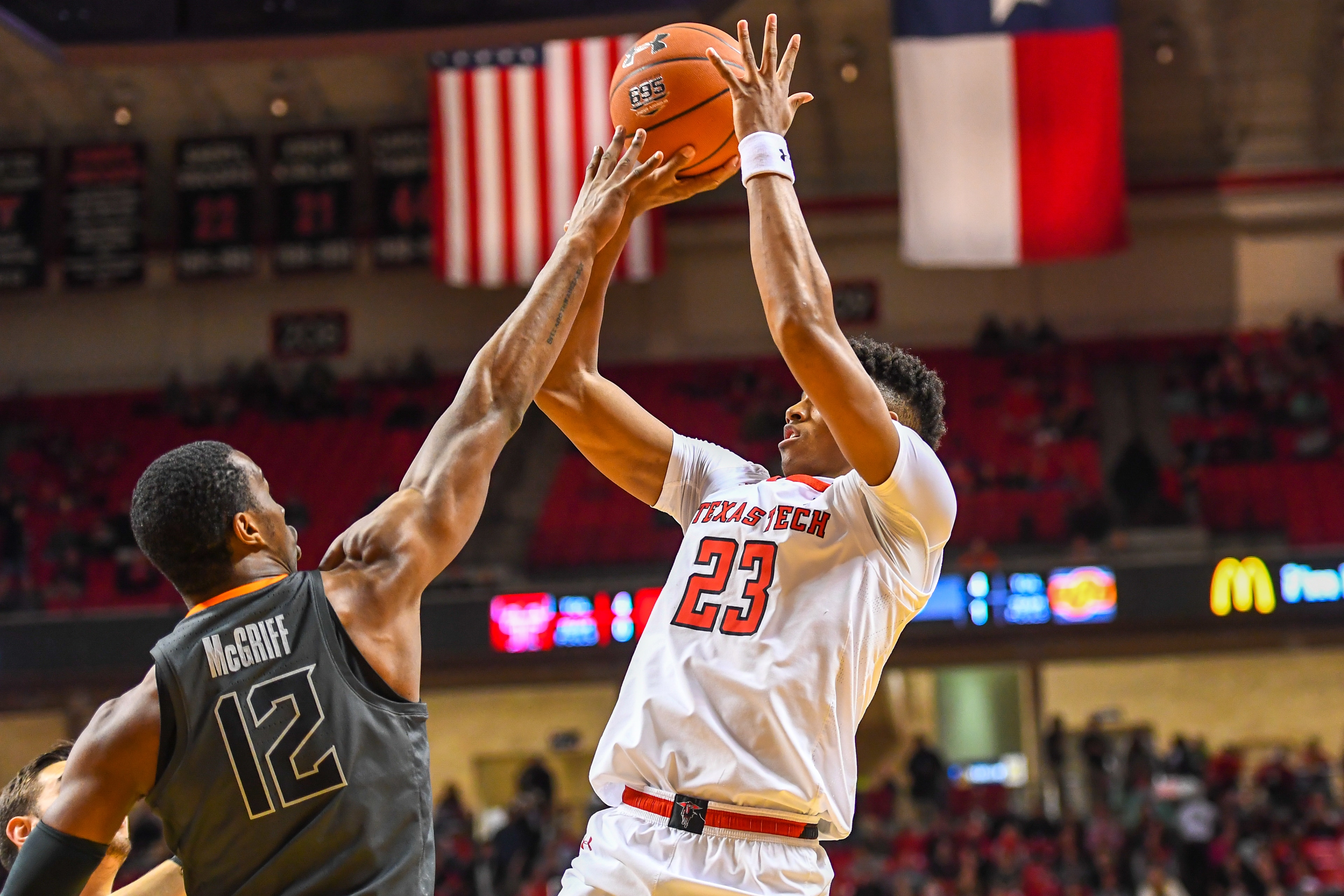 LUBBOCK, TX - FEBRUARY 27: Jarrett Culver #23 of the Texas Tech Red Raiders shoots the ball over Cameron McGriff #12 of the Oklahoma State Cowboys during the first half of the game on February 27, 2019 at United Supermarkets Arena in Lubbock, Texas. (Phot