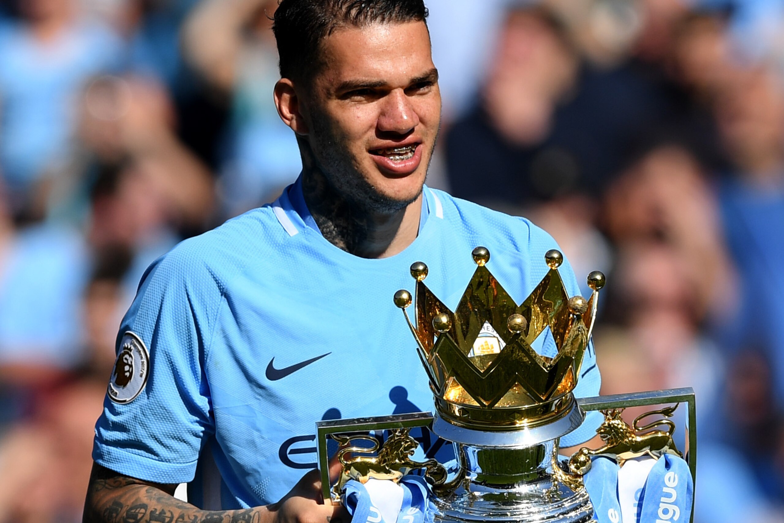 MANCHESTER, ENGLAND - MAY 06:  Ederson of Manchester City celebrates with The Premier League Trophy after the Premier League match between Manchester City and Huddersfield Town at Etihad Stadium on May 6, 2018 in Manchester, England.  (Photo by Shaun Bott