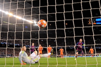 Barcelona's Argentinian forward Lionel Messi (2R) scores a penalty kick against Lyon's Portuguese goalkeeper Anthony Lopes during the UEFA Champions League round of 16, second leg football match between FC Barcelona and Olympique Lyonnais at the Camp Nou 