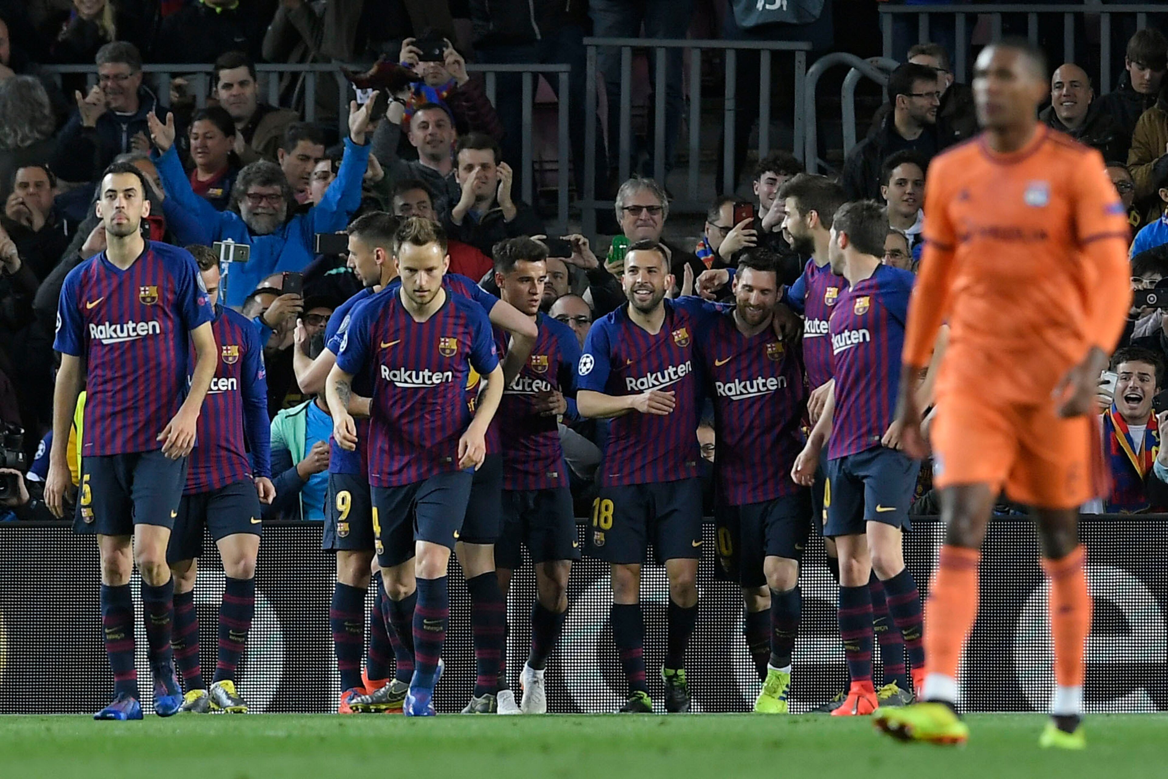 Barcelona's Argentinian forward Lionel Messi (3R) celebrates a goal with teammates after shooting a penalty kick during the UEFA Champions League round of 16, second leg football match between FC Barcelona and Olympique Lyonnais at the Camp Nou stadium in