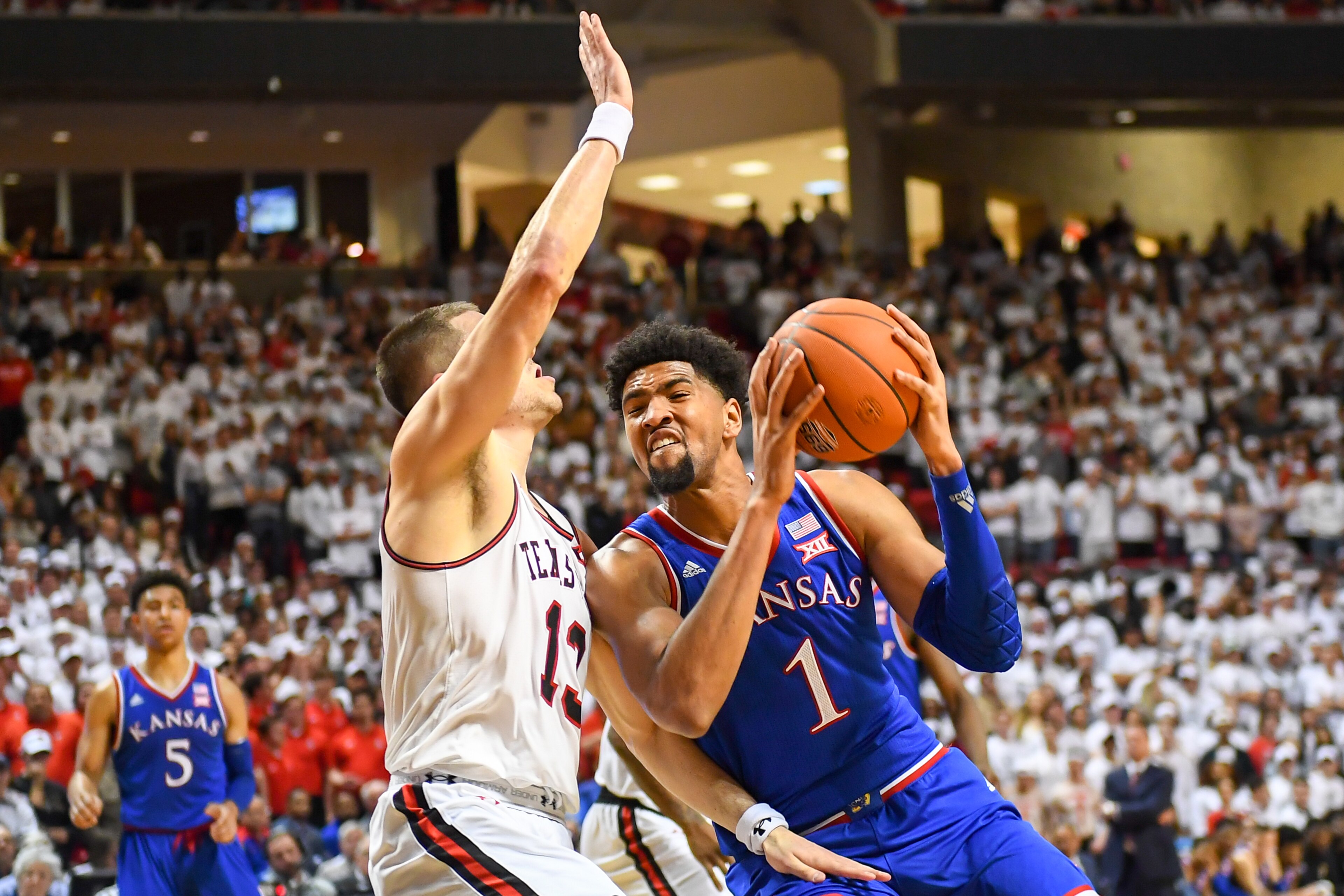 LUBBOCK, TX - FEBRUARY 23: Dedric Lawson #1 of the Kansas Jayhawks goes to the basket against Matt Mooney #13 of the Texas Tech Red Raiders during the game on February 23, 2019 at United Supermarkets Arena in Lubbock, Texas. Texas Tech defeated Kansas 91- LUBBOCK, TX - FEBRUARY 23: Dedric Lawson #1 of the Kansas Jayhawks goes to the basket against Matt Mooney #13 of the Texas Tech Red Raiders during the game on February 23, 2019 at United Supermarkets Arena in Lubbock, Texas. Texas Tech defeated Kansas 91-