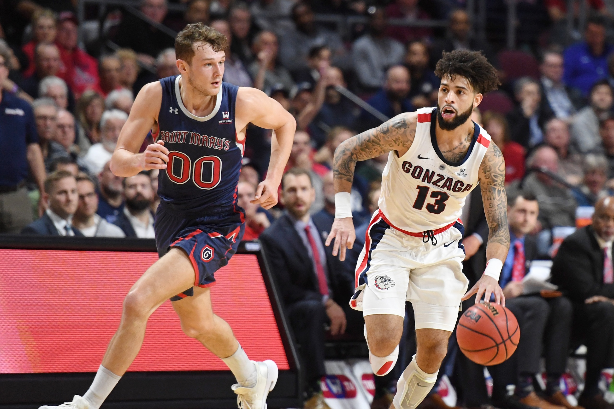 LAS VEGAS, NEVADA - MARCH 12:  Josh Perkins #13 of the Gonzaga Bulldogs brings the ball up the court after stealing the ball from Tanner Krebs #00 of the Saint Mary's Gaels during the championship game of the West Coast Conference basketball tournament at