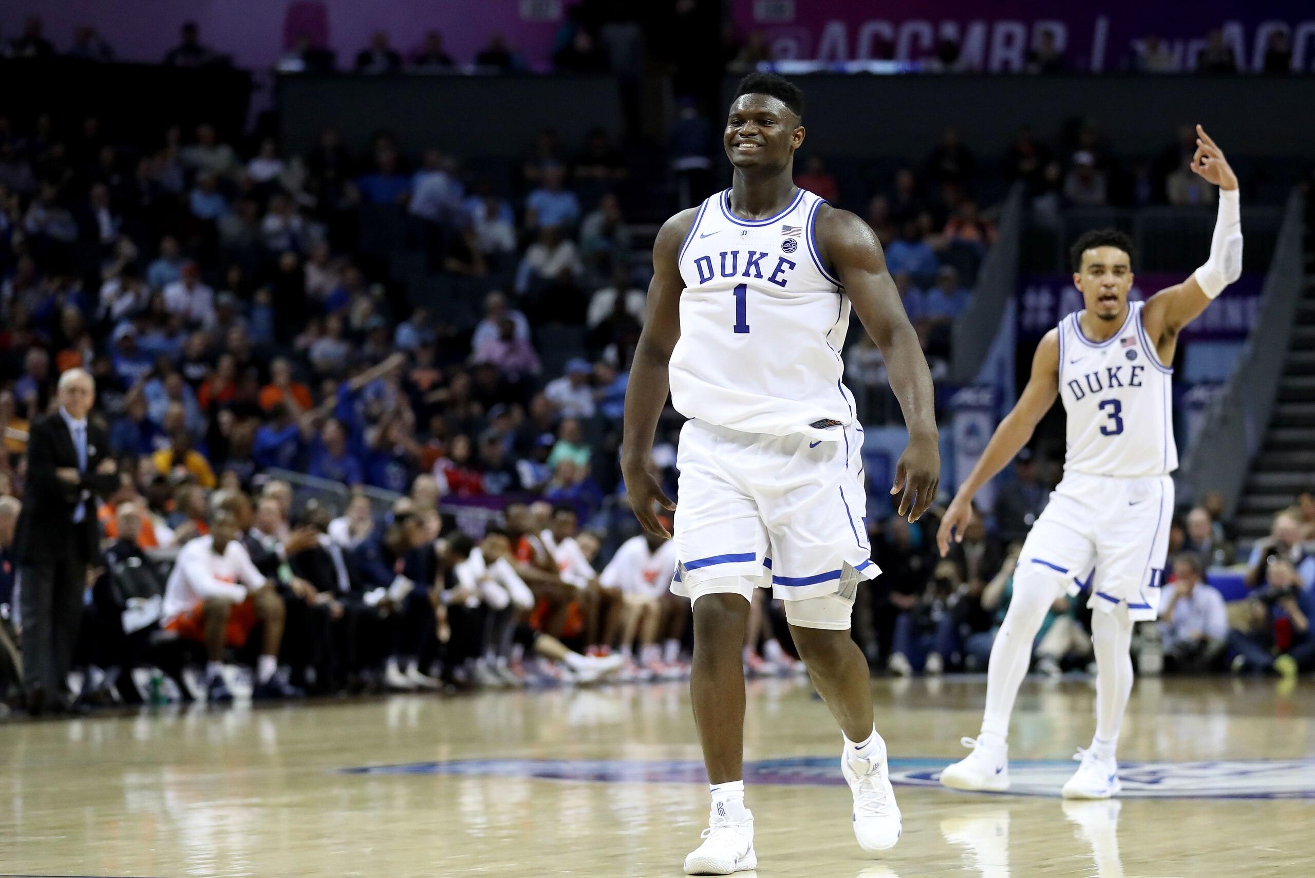 CHARLOTTE, NORTH CAROLINA - MARCH 14: Teammates Zion Williamson #1 and Tre Jones #3 of the Duke Blue Devils react after defeating the Syracuse Orange 84-72 during their game in the quarterfinal round of the 2019 Men's ACC Basketball Tournament at Spectrum