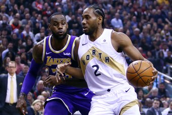 TORONTO, ON - MARCH 14:  Kawhi Leonard #2 of the Toronto Raptors dribbles the ball as LeBron James #23 of the Los Angeles Lakers defends during the first half of an NBA game at Scotiabank Arena on March 14, 2019 in Toronto, Canada.  NOTE TO USER: User exp