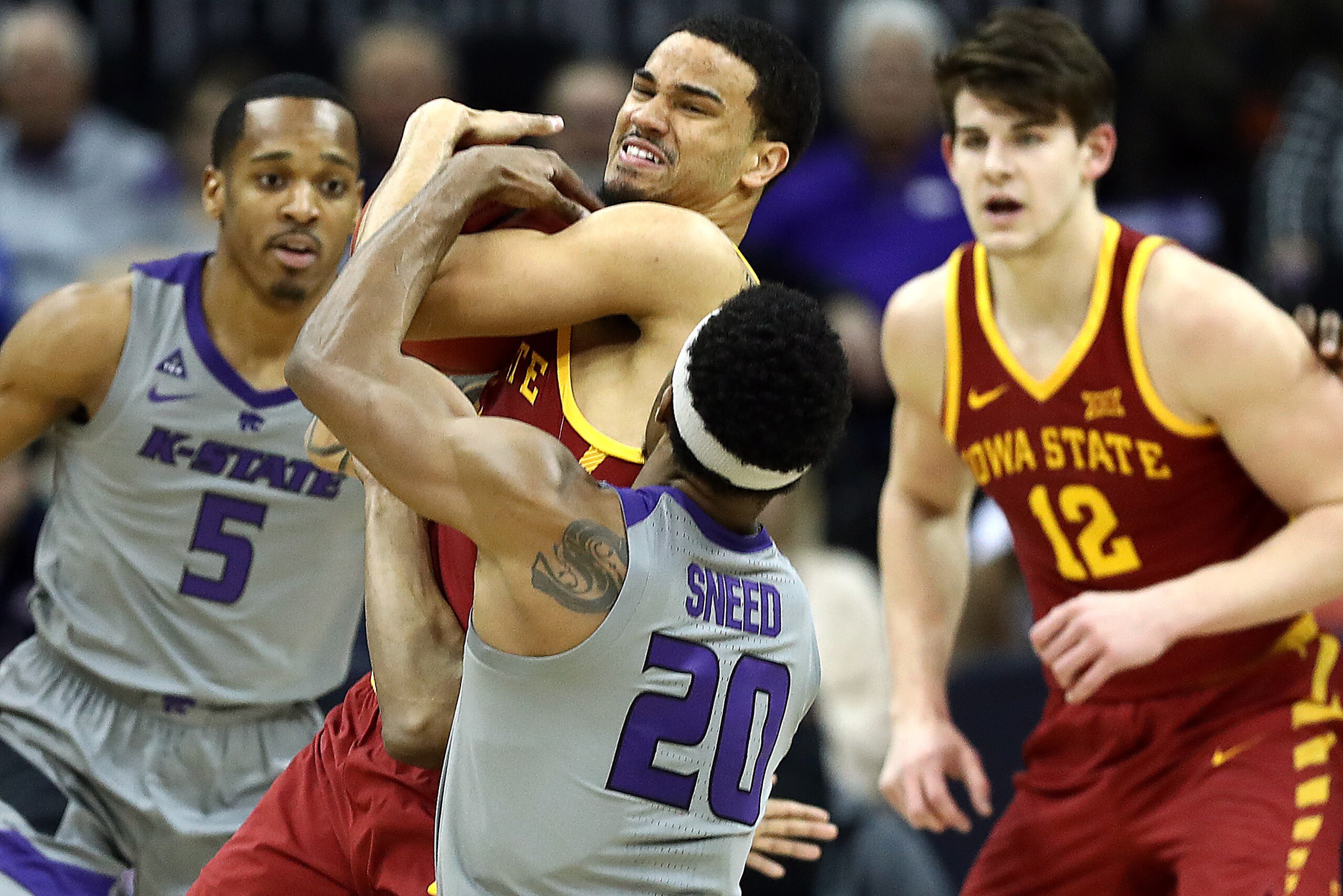 KANSAS CITY, MISSOURI - MARCH 15:  Nick Weiler-Babb #1 of the Iowa State Cyclones controls the ball as Xavier Sneed #20 of the Kansas State Wildcats tries to wrestle it away during the semifinal game of the Big 12 Basketball Tournament at Sprint Center on