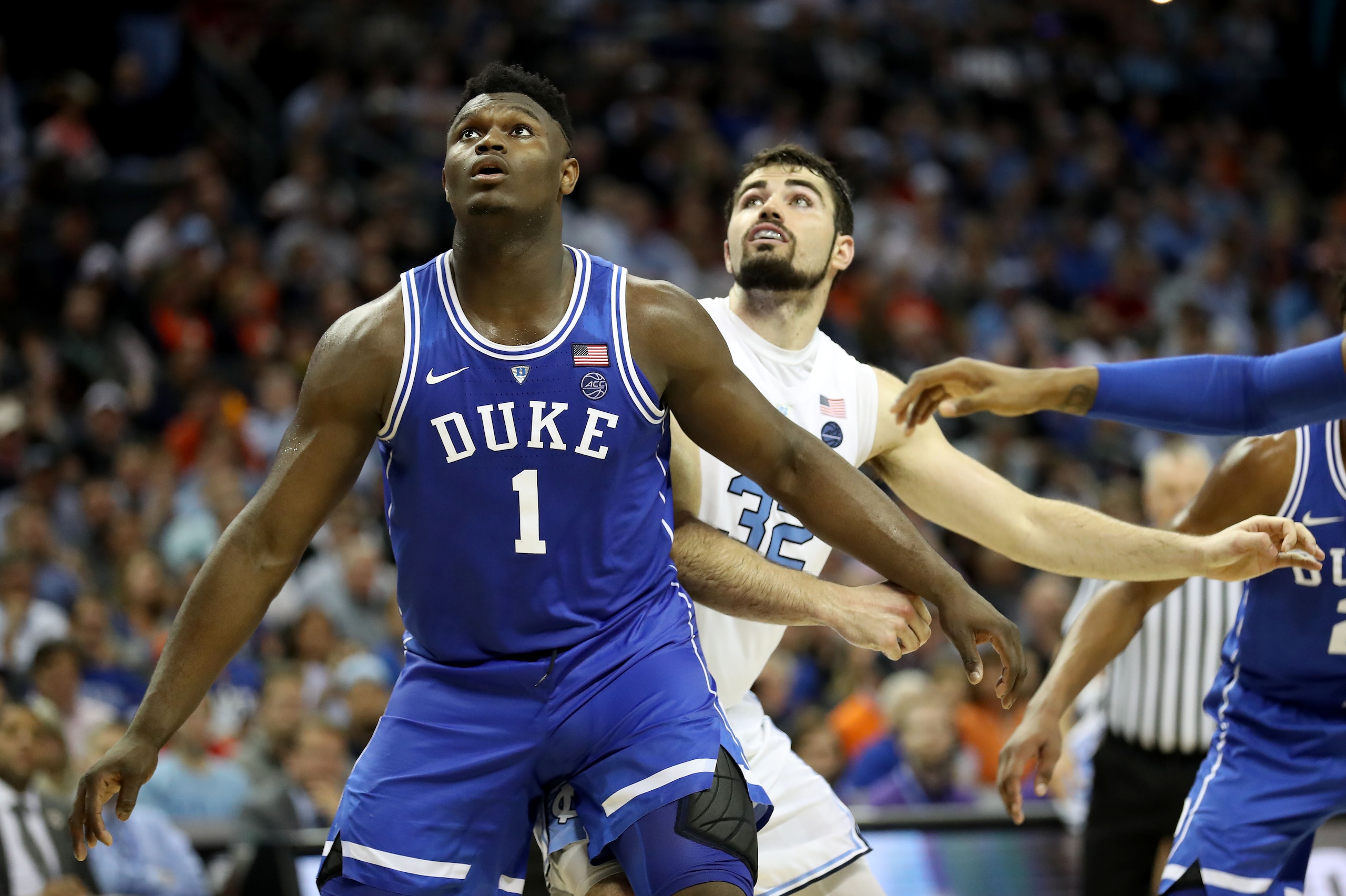 CHARLOTTE, NORTH CAROLINA - MARCH 15: Zion Williamson #1 of the Duke Blue Devils waits for a rebound with Luke Maye #32 of the North Carolina Tar Heels during their game in the semifinals of the 2019 Men's ACC Basketball Tournament at Spectrum Center on M