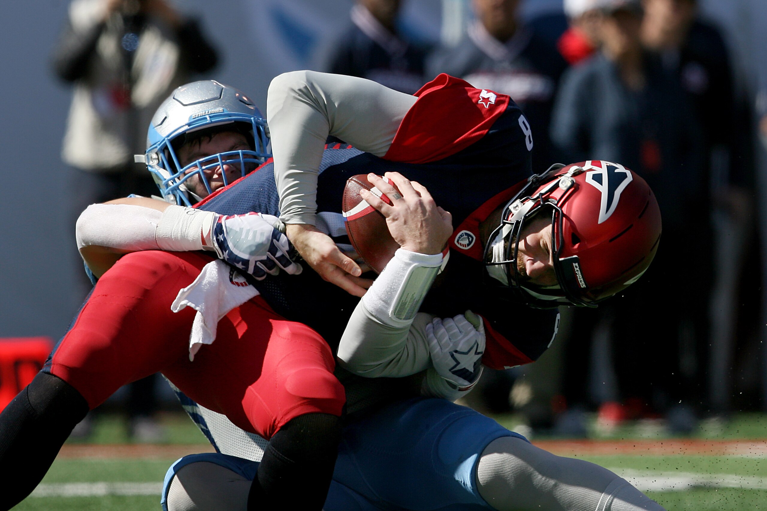SALT LAKE CITY, UTAH - MARCH 16:  Quarterback Zach Mettenberger #8 of the Memphis Express is sacked by Karter Schult #94 of the Salt Lake Stallions in the first quarter at Rice Eccles Stadium on March 16, 2019 in Salt Lake City, Utah. (Photo by Chris Gard
