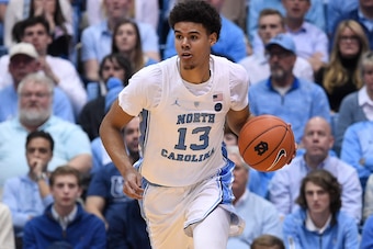 CHAPEL HILL, NORTH CAROLINA - FEBRUARY 26: Cameron Johnson #13 of the North Carolina Tar Heels moves the ball against the Syracuse Orange during their game at the Dean Smith Center on February 26, 2019 in Chapel Hill, North Carolina. North Carolina won 93