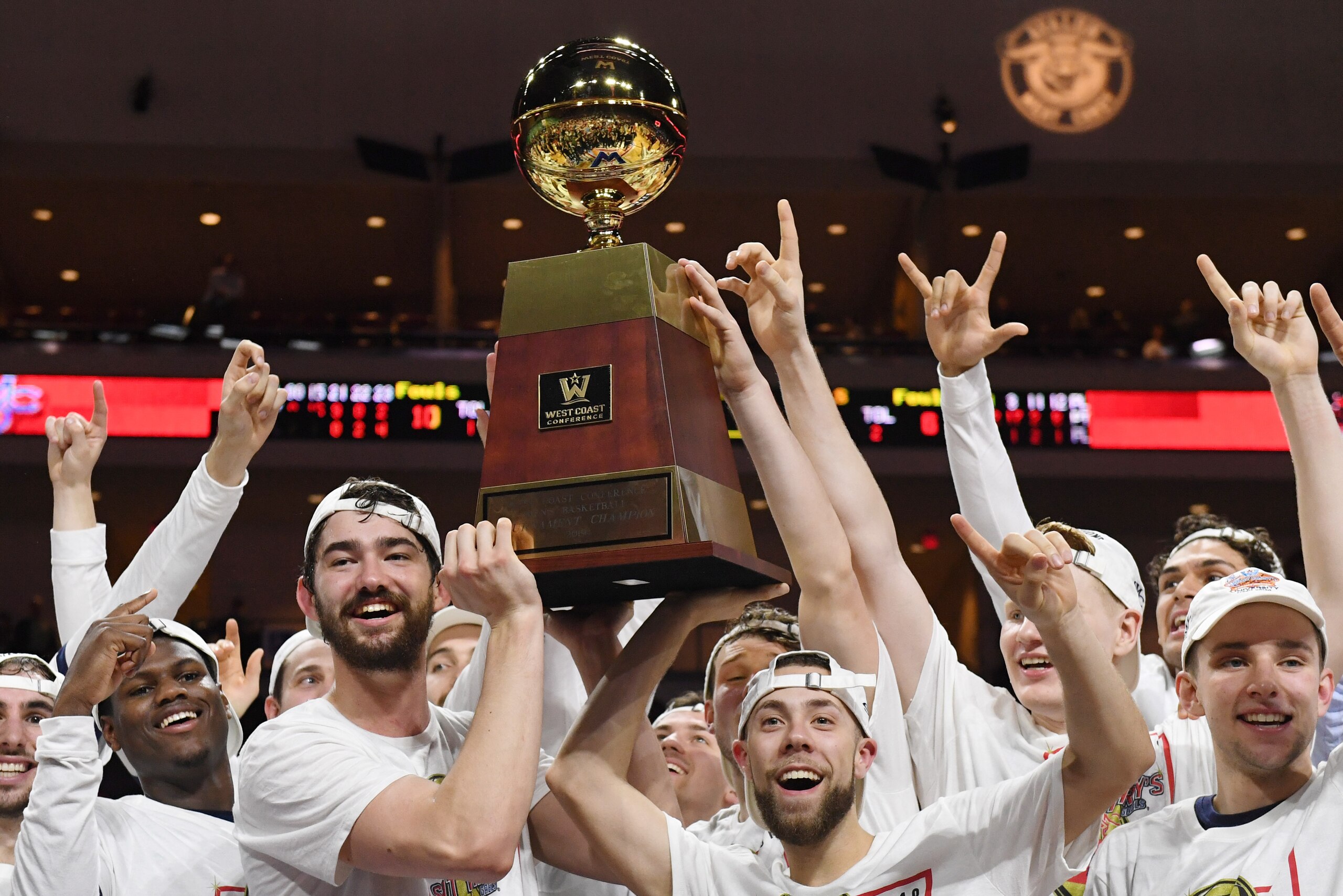 LAS VEGAS, NEVADA - MARCH 12:  Jordan Hunter (L) #1 and Jordan Ford #3 of the Saint Mary's Gaels hold up the trophy as the team celebrates defeating the Gonzaga Bulldogs 60-47 to win the championship game of the West Coast Conference basketball tournament