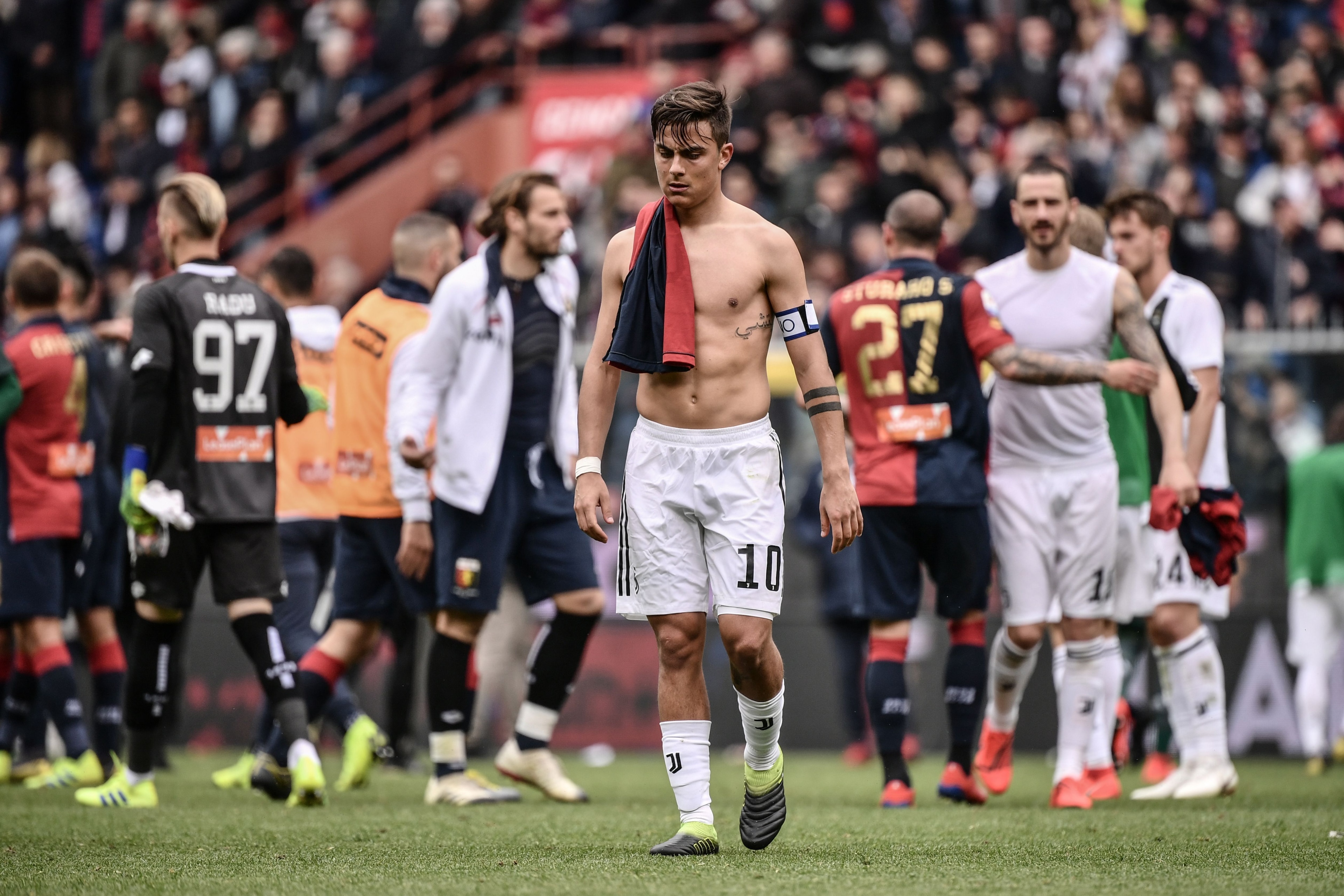 Juventus' Argentine forward Paulo Dybala (C) leaves the pitch at the end of the Italian Serie A football Match Genoa vs Juventus on March 17, 2019 at the Luigi-Ferraris stadium in Genoa. (Photo by Marco BERTORELLO / AFP)        (Photo credit should read M