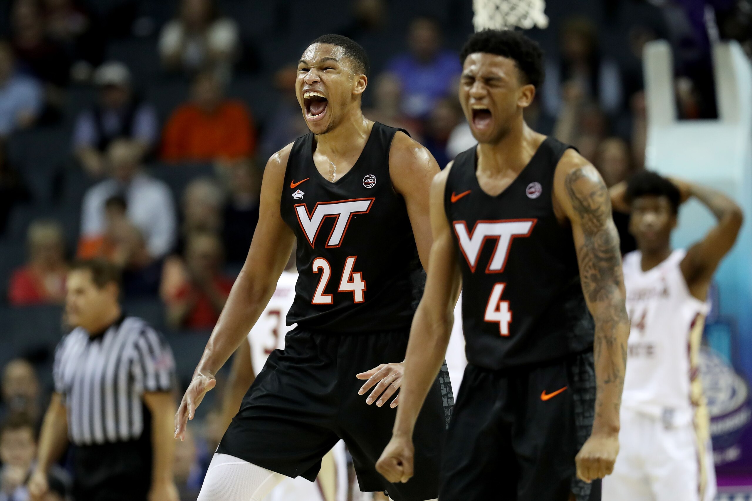 CHARLOTTE, NORTH CAROLINA - MARCH 14: Teammates Kerry Blackshear Jr. #24 and Nickeil Alexander-Walker #4 of the Virginia Tech Hokies react against the Florida State Seminoles during their game in the quarterfinal round of the 2019 Men's ACC Basketball Tou