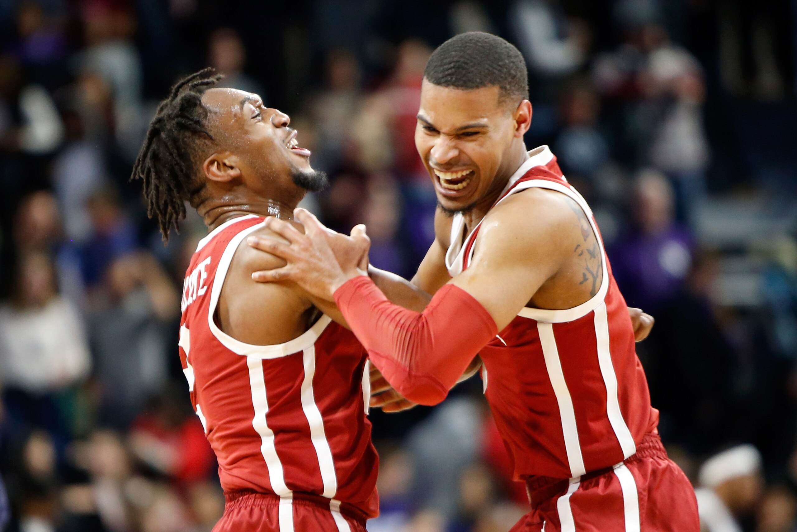 EVANSTON, ILLINOIS - DECEMBER 21: Aaron Calixte #2 and Christian James #0 of the Oklahoma Sooners celebrate a victory over the Northwestern Wildcats at Welsh-Ryan Arena on December 21, 2018 in Evanston, Illinois. (Photo by Justin Casterline/Getty Images)