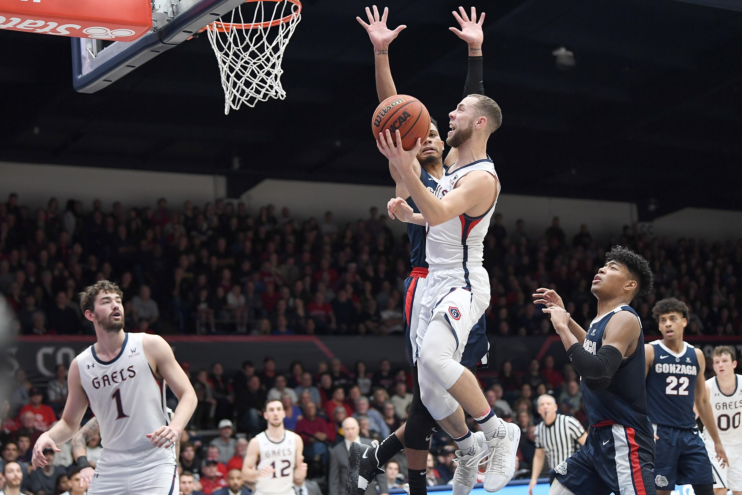 MORAGA, CA - MARCH 02:  Jordan Ford #3 of the Saint Mary's Gaels goes in for a layup over Geno Crandall #0 of the Gonzaga Bulldogs during the second half of their NCAA college basketball game at McKeon Pavilion on March 2, 2019 in Moraga, California.  (Ph