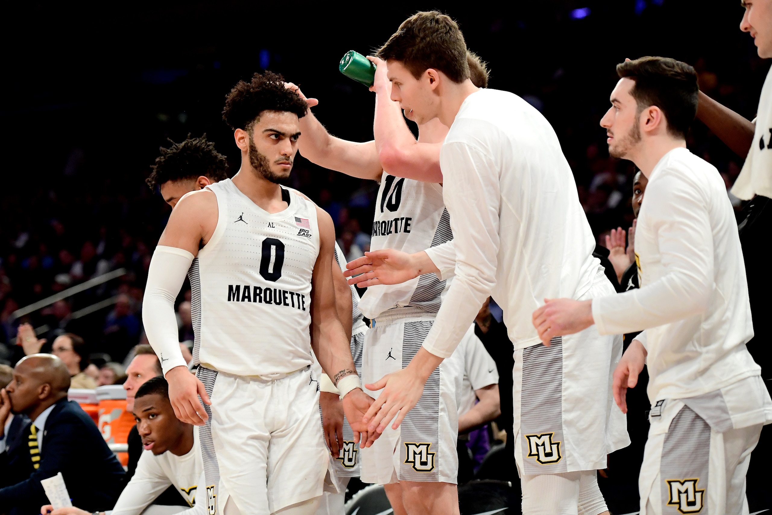 NEW YORK, NEW YORK - MARCH 14:  Markus Howard #0 of the Marquette Golden Eagles celebrates his teams lead with his teammate against the St. John's Red Storm during the Quarterfinals of the 2019 Big East men's basketball tournament at Madison Square Garden