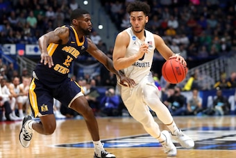 HARTFORD, CONNECTICUT - MARCH 21:  Markus Howard #0 of the Marquette Golden Eagles drives the ball past Shaq Buchanan #11 of the Murray State Racers during the first round game of the 2019 NCAA Men's Basketball Tournament at XL Center on March 21, 2019 in