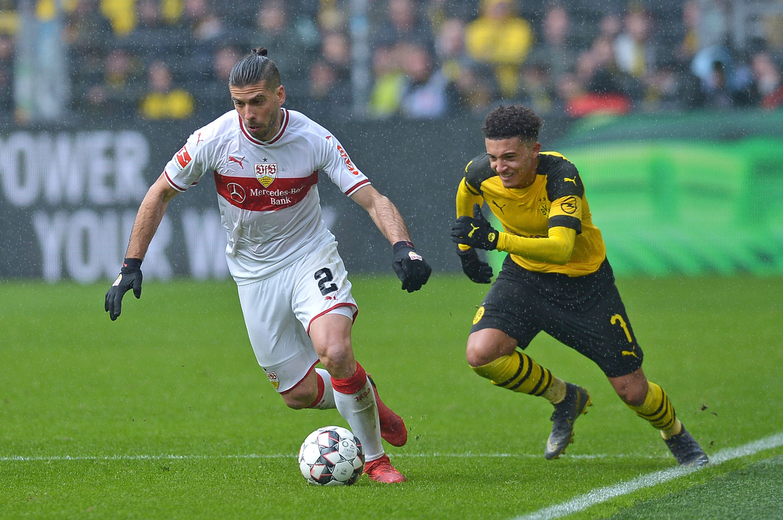 DORTMUND, GERMANY - MARCH 09: Emiliano Insua of VfB Stuttgart and Jadon Sancho of Borussia Dortmund battle for the ball during the Bundesliga match between Borussia Dortmund and VfB Stuttgart at Signal Iduna Park on March 9, 2019 in Dortmund, Germany. (Ph