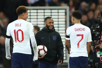 LONDON, ENGLAND - MARCH 22: Raheem Sterling of England walks off with the match ball as he speaks to Dele Alli and Jadon Sancho during the 2020 UEFA European Championships group A qualifying match between England and Czech Republic at Wembley Stadium on M