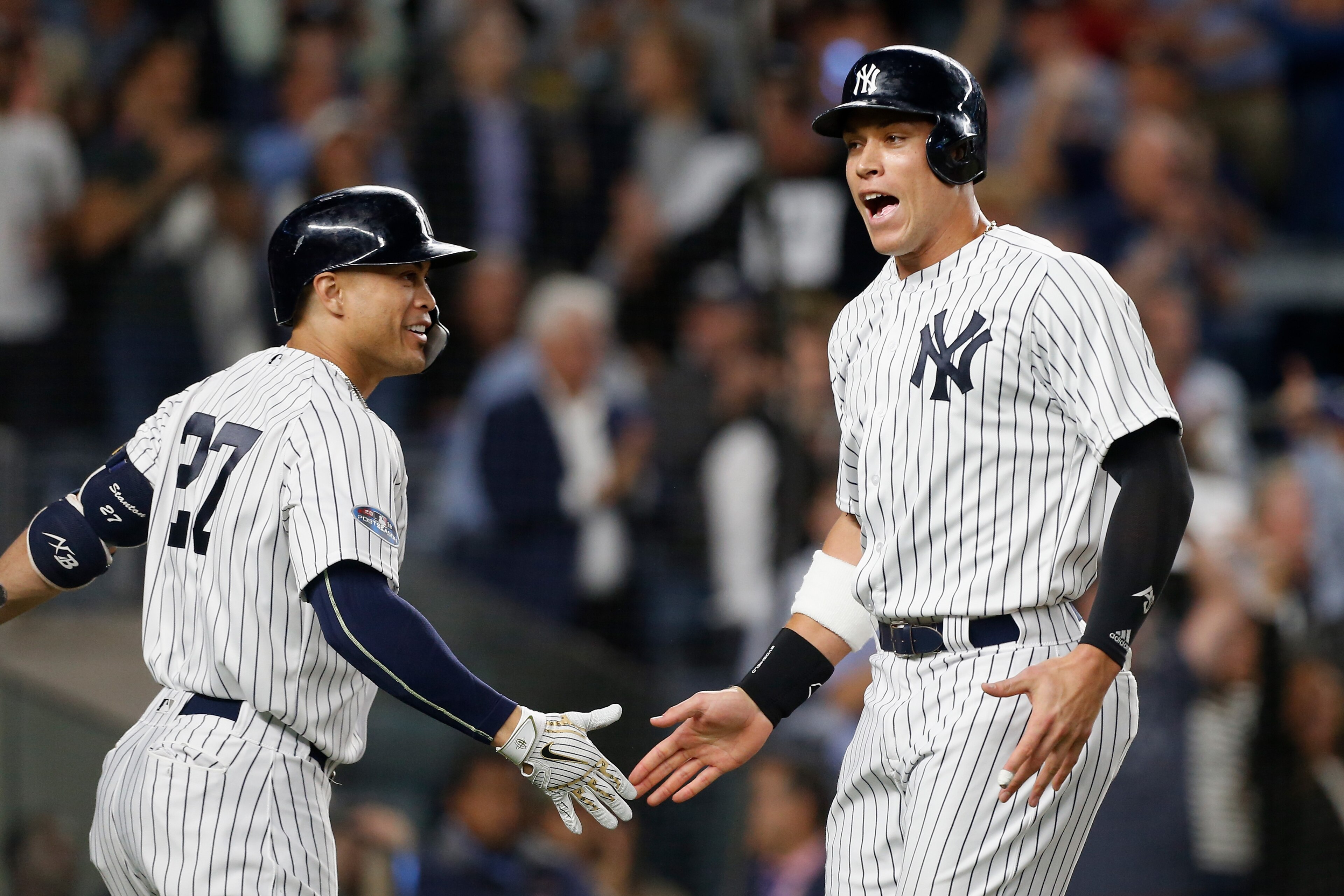 NEW YORK, NY - OCTOBER 03:  (NEW YORK DAILIES OUT)   Aaron Judge #99 and Giancarlo Stanton #27 of the New York Yankees during the sixth inning against the Oakland Athletics in the American League Wild Card Game at Yankee Stadium on October 3, 2018 in the 