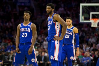 PHILADELPHIA, PA - MARCH 20: Jimmy Butler #23, Joel Embiid #21, and Ben Simmons #25 of the Philadelphia 76ers look on against the Boston Celtics in the third quarter at the Wells Fargo Center on March 20, 2019 in Philadelphia, Pennsylvania. The 76ers defe
