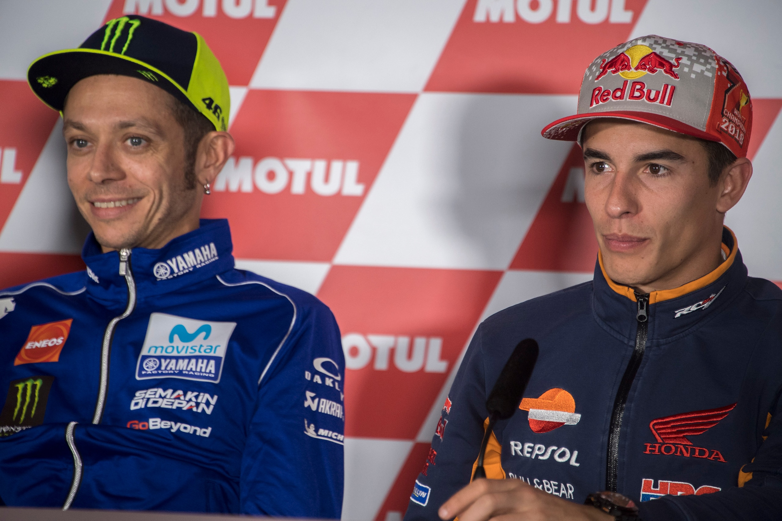 VALENCIA, SPAIN - NOVEMBER 15:  Valentino Rossi of Italy and Movistar Yamaha MotoGP smiles (L) and  Marc Marquez of Spain and Repsol Honda Team looks on during the press conference pre-event during the MotoGP Of Valencia - Previews at Ricardo Tormo Circui