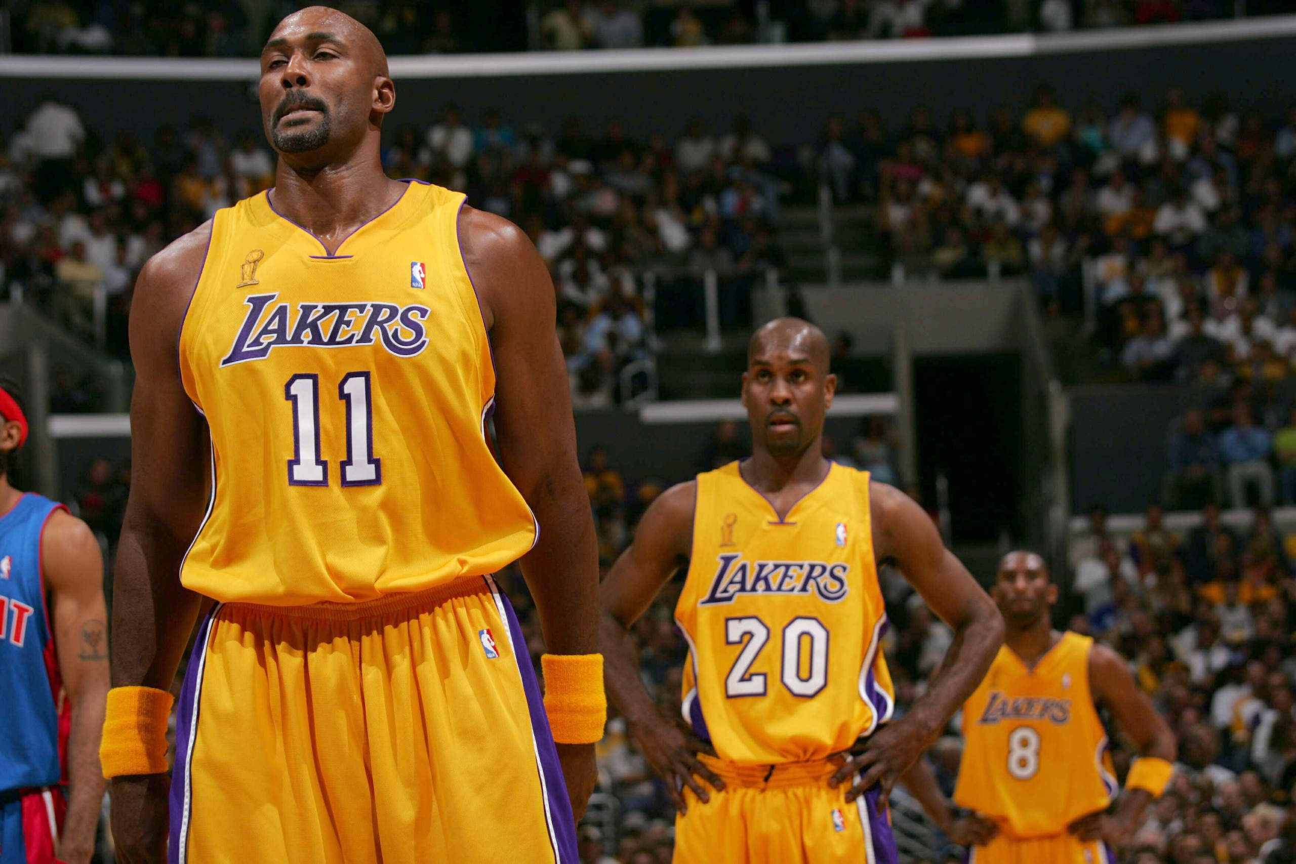 LOS ANGELES - JUNE 8: Karl Malone #11, Gary Payton #20 and Kobe Bryant #8 of the Los Angeles Lakers looks on in Game two of the 2004 NBA Finals against the Detroit Pistons   June 8, 2004 at Staples Center in Los Angeles, California.  NOTE TO USER: User ex