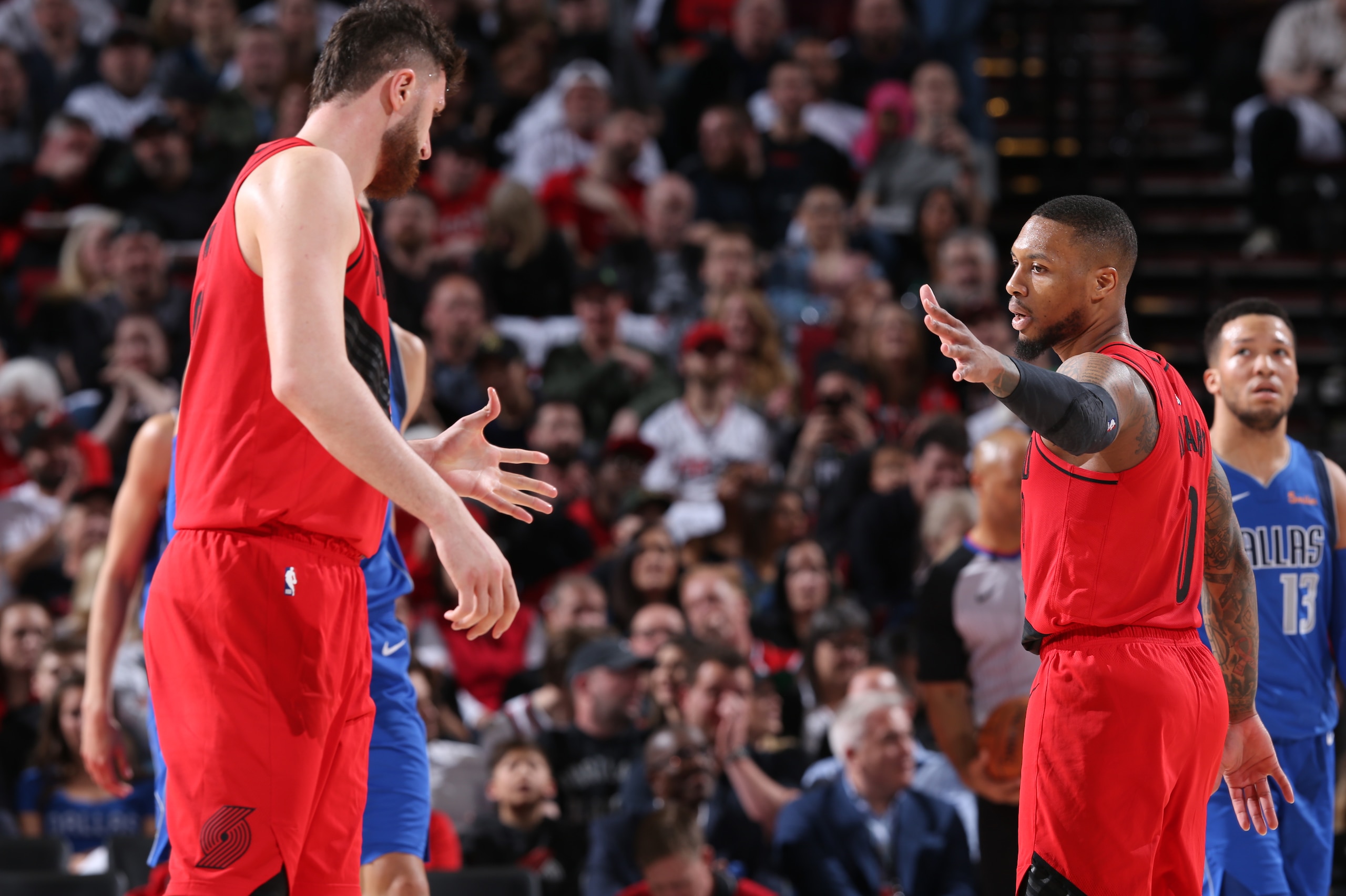 PORTLAND, OR - MARCH 20: Damian Lillard #0 hi-fives Jusuf Nurkic #27 of the Portland Trail Blazers during the game on March 20, 2019 at the Moda Center Arena in Portland, Oregon. NOTE TO USER: User expressly acknowledges and agrees that, by downloading an