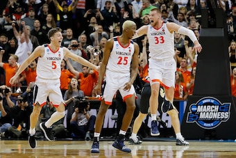 LOUISVILLE, KENTUCKY - MARCH 30:  Mamadi Diakite #25 of the Virginia Cavaliers celebrates after making a game-tying shot over Matt Haarms #32 of the Purdue Boilermakers to extend the game to overtime as time expires in the second half of the 2019 NCAA Men