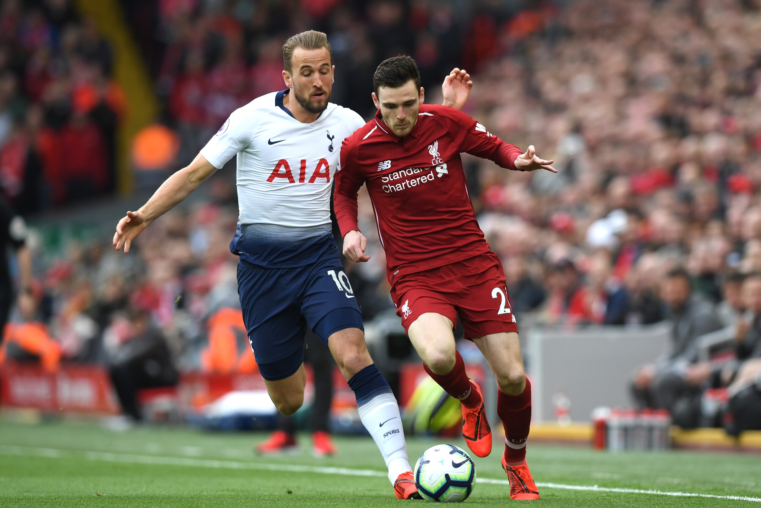 LIVERPOOL, ENGLAND - MARCH 31:  Harry Kane of Tottenham Hotspur chases Andrew Robertson of Liverpool during the Premier League match between Liverpool FC and Tottenham Hotspur at Anfield on March 31, 2019 in Liverpool, United Kingdom. (Photo by Shaun Bott