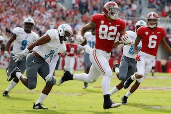 TUSCALOOSA, AL - NOVEMBER 17:  Irv Smith Jr. #82 of the Alabama Crimson Tide breaks away with a reception on the way to a touchdown against Joshua Bowers #3 of the Citadel Bulldogs at Bryant-Denny Stadium on November 17, 2018 in Tuscaloosa, Alabama.  (Pho