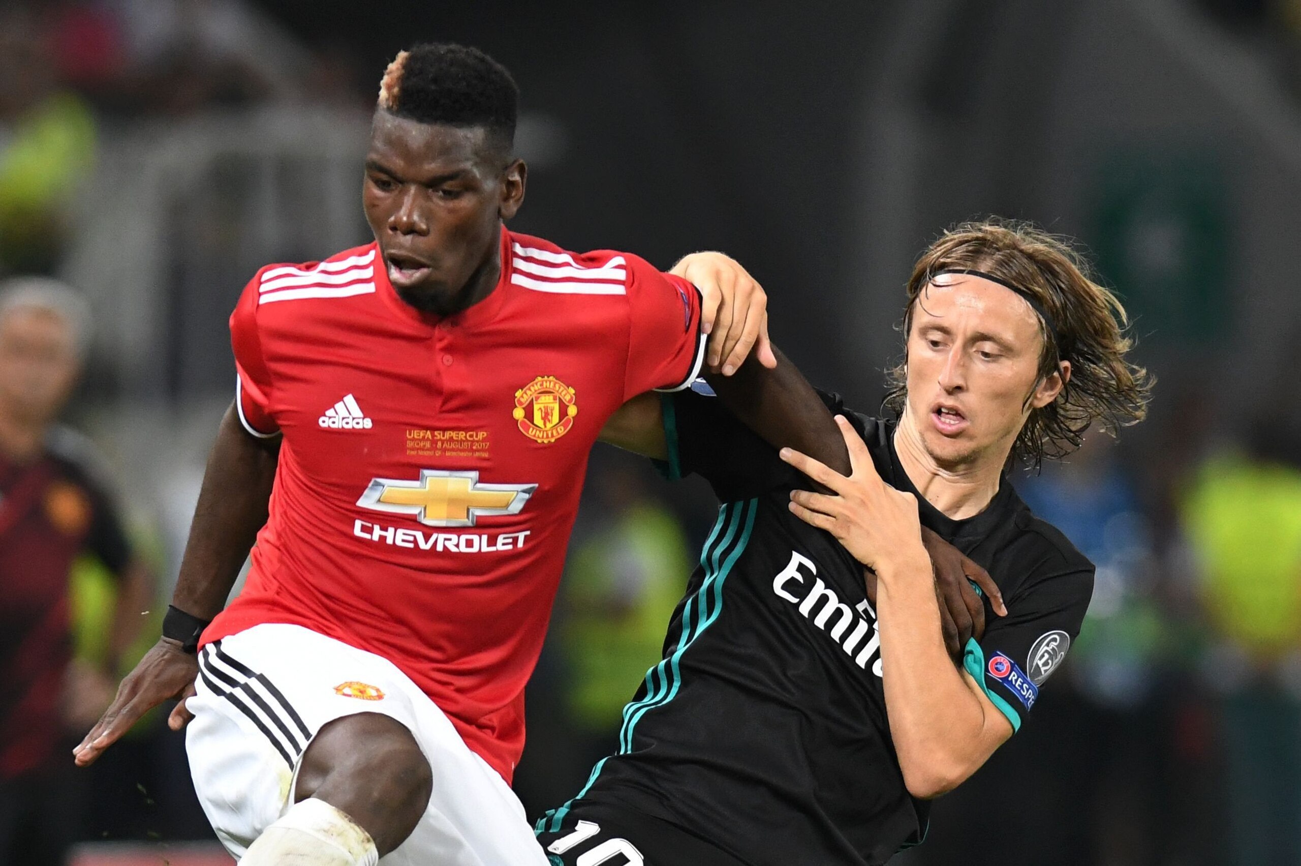 Manchester United's French midfielder Paul Pogba (L) vies with Real Madrid's Croatian midfielder Luka Modric during the UEFA Super Cup football match between Real Madrid and Manchester United on August 8, 2017, at the Philip II Arena in Skopje. / AFP PHOT