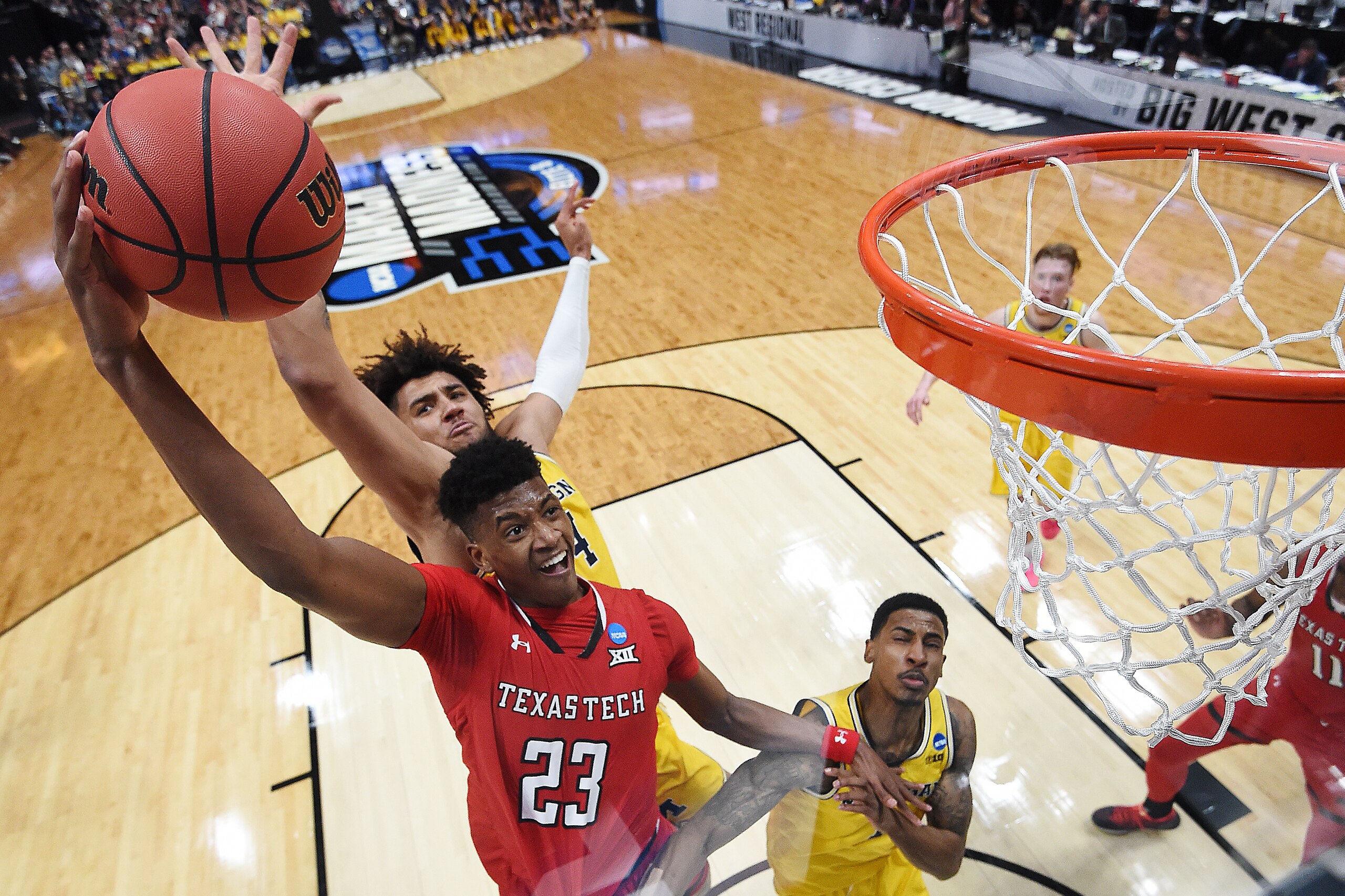 ANAHEIM, CALIFORNIA - MARCH 28: Jarrett Culver #23 of the Texas Tech Red Raiders drives to the basket against Isaiah Livers #4 and Charles Matthews #1 of the Michigan Wolverines during during the 2019 NCAA Men's Basketball Tournament West Regional at Hond