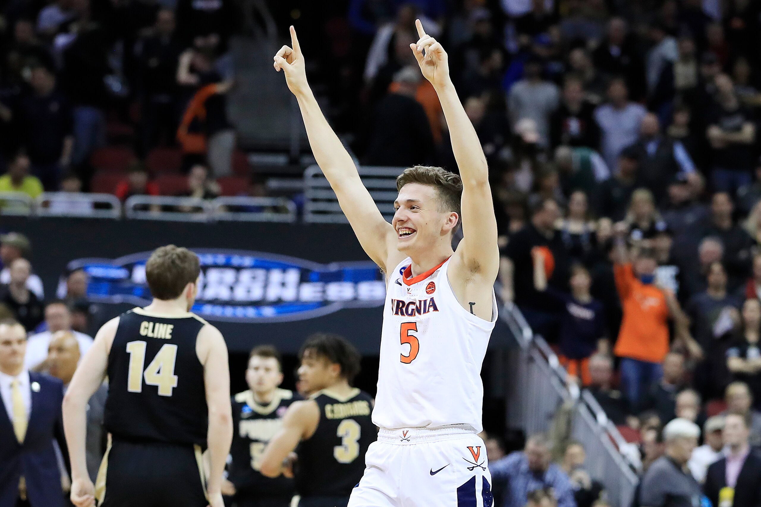 LOUISVILLE, KENTUCKY - MARCH 30:  Kyle Guy #5 of the Virginia Cavaliers celebrates after defeating the Purdue Boilermakers 80-75 to advance to the Final Four in overtime of the 2019 NCAA Men's Basketball Tournament South Regional at KFC YUM! Center on Mar