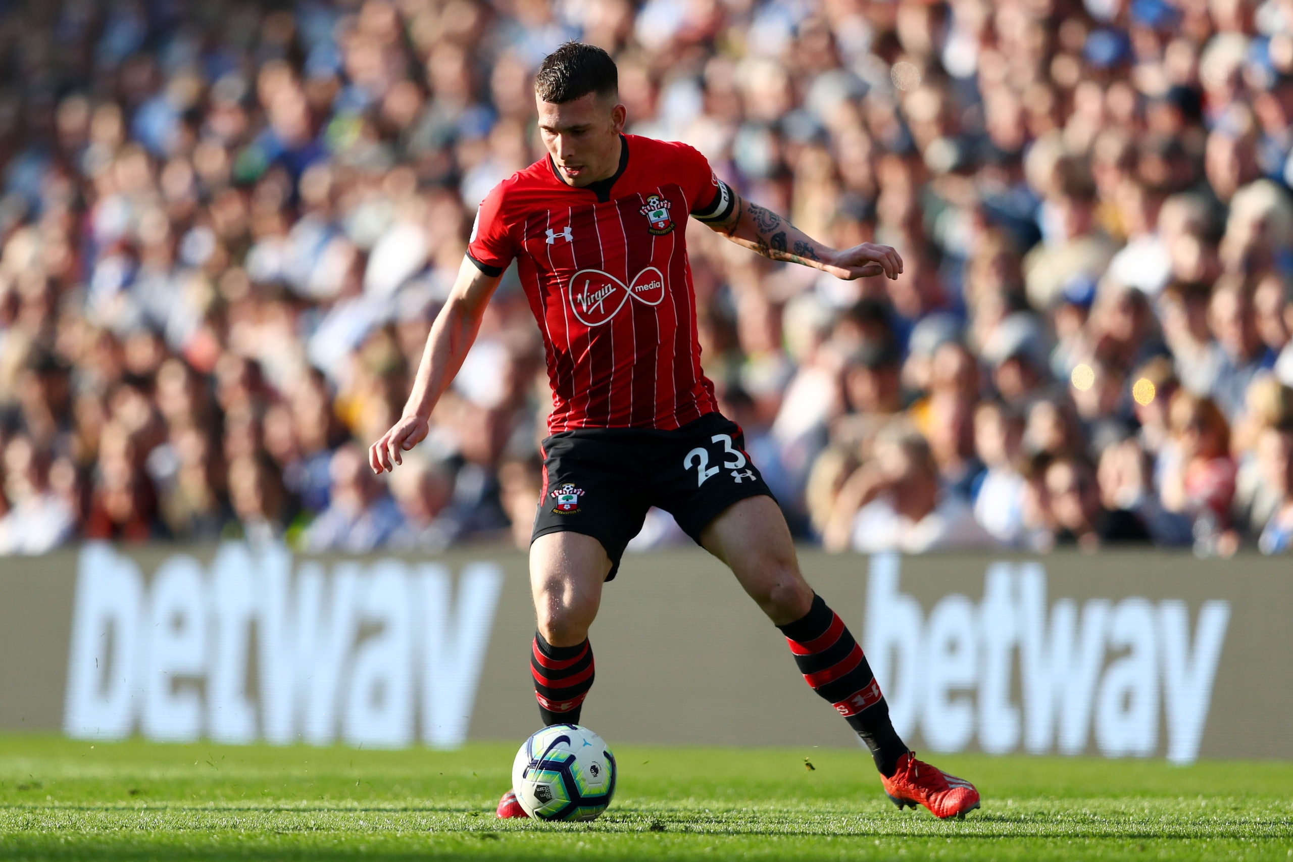 BRIGHTON, ENGLAND - MARCH 30:   Pierre-Emile Hojbjerg of Southampton runs with the ball during the Premier League match between Brighton & Hove Albion and Southampton FC at American Express Community Stadium on March 30, 2019 in Brighton, United Kingdom. 