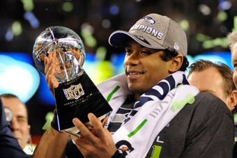 EAST RUTHERFORD, NJ - FEBRUARY 02:  Quarterback Russell Wilson #3 of the Seattle Seahawks holding the Lombardi Trophy after they defeated the Denver Broncos in Super Bowl XLVIII on February 2, 2014 at MetLife Stadium in East Rutherford, New Jersey. The Se