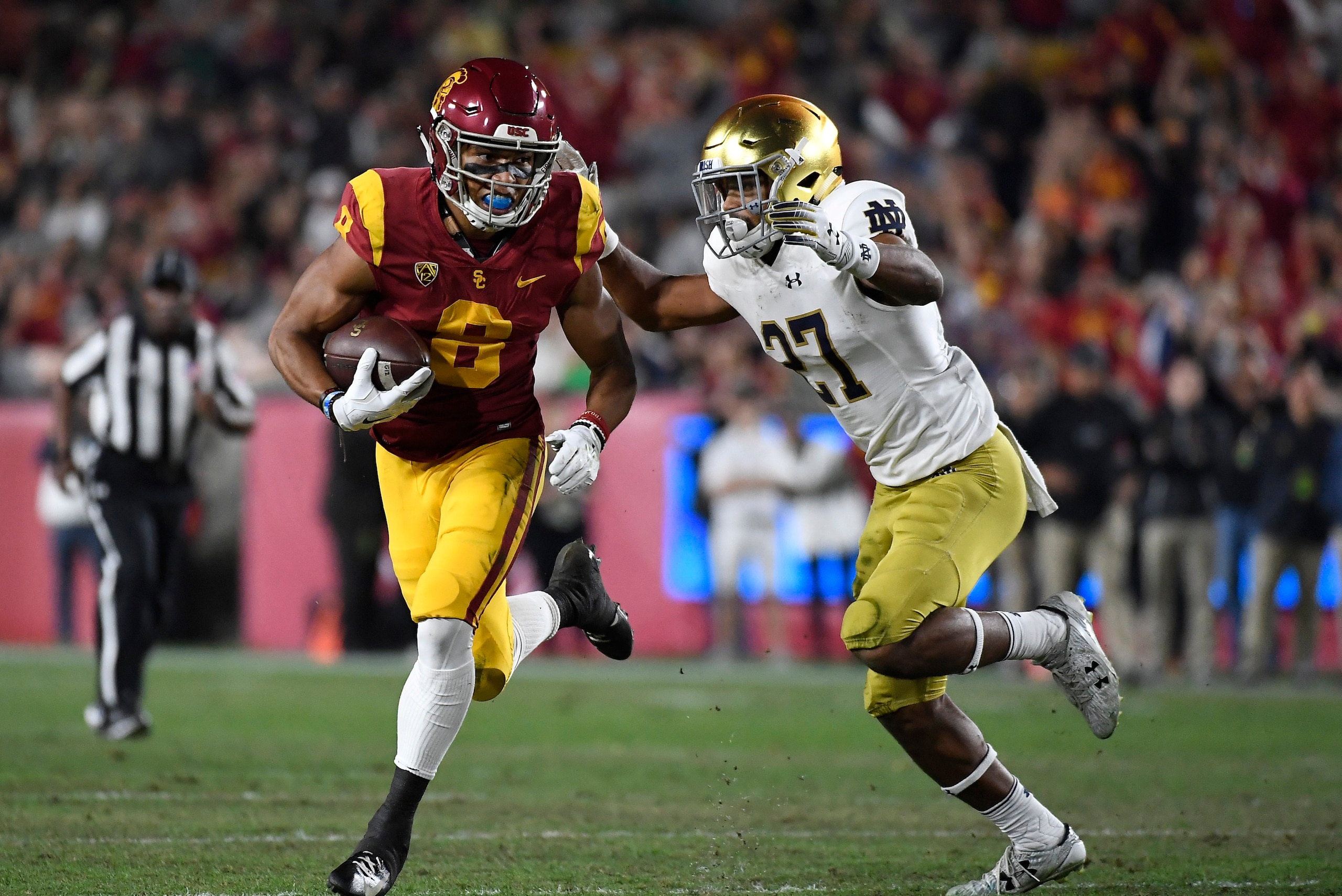 LOS ANGELES, CA - NOVEMBER 24: Amon-Ra St. Brown #8 of the USC Trojans runs after catching a pass against Julian Love #27 of the Notre Dame Fighting Irish in the first half at Los Angeles Memorial Coliseum on November 24, 2018 in Los Angeles, California. LOS ANGELES, CA - NOVEMBER 24: Amon-Ra St. Brown #8 of the USC Trojans runs after catching a pass against Julian Love #27 of the Notre Dame Fighting Irish in the first half at Los Angeles Memorial Coliseum on November 24, 2018 in Los Angeles, California.