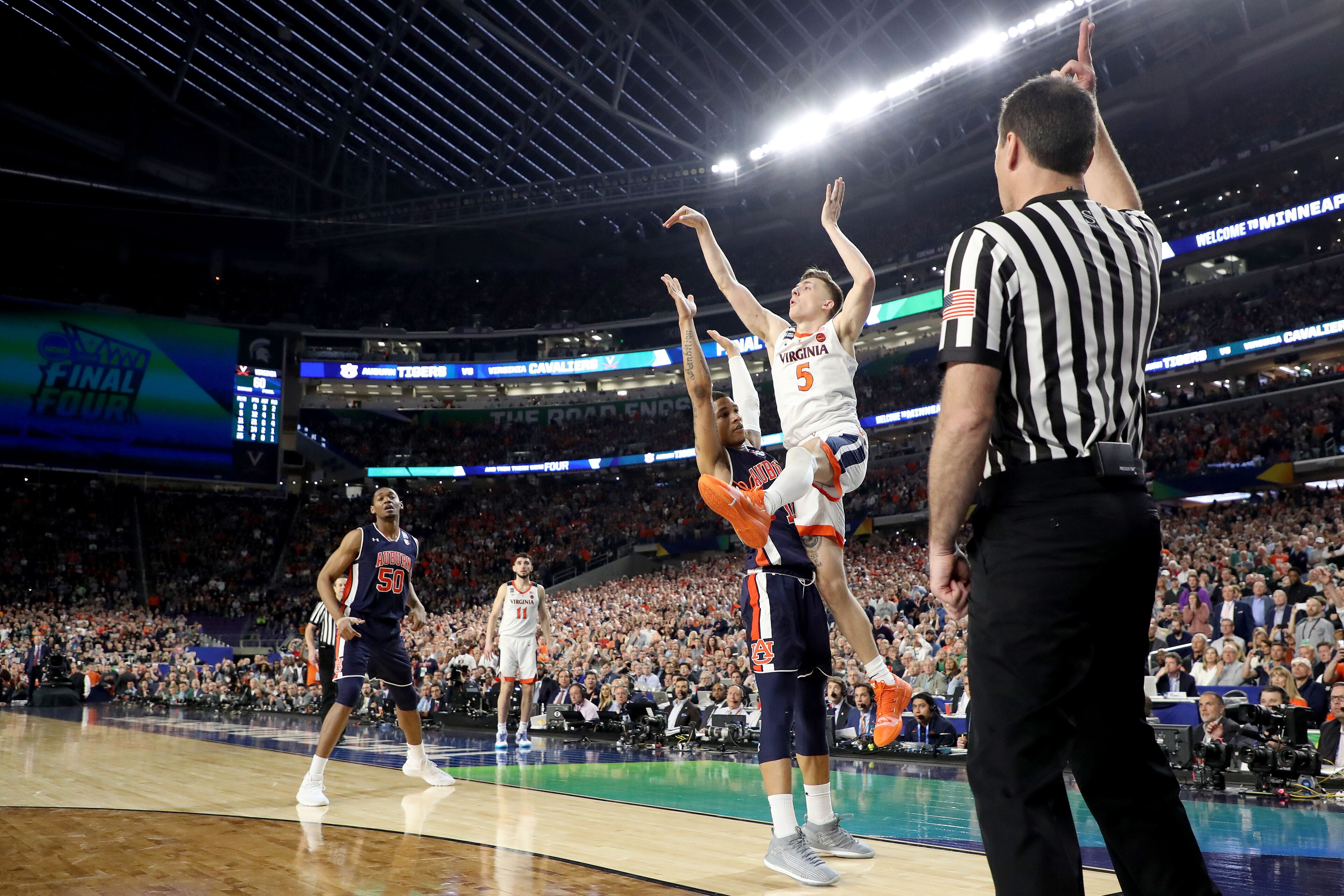 MINNEAPOLIS, MINNESOTA - APRIL 06: Kyle Guy #5 of the Virginia Cavaliers attempts a game-winning three point basket as he is fouled by Samir Doughty #10 of the Auburn Tigers in the second half during the 2019 NCAA Final Four semifinal at U.S. Bank Stadium