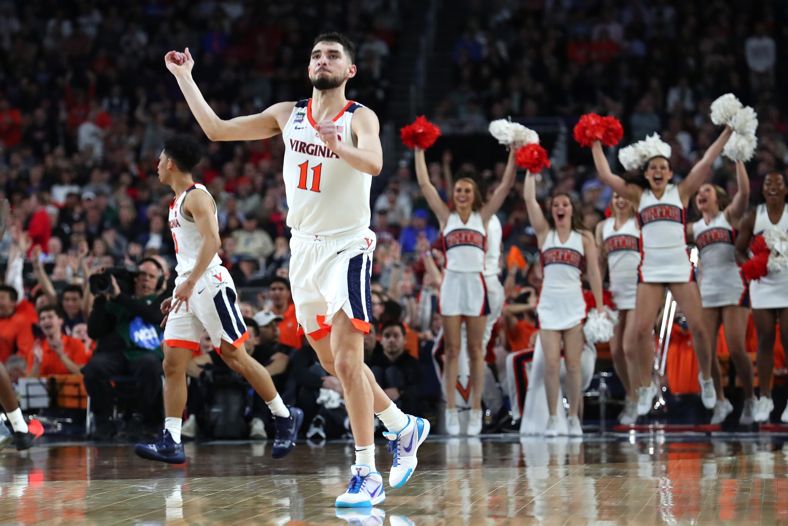 MINNEAPOLIS, MINNESOTA - APRIL 06: Ty Jerome #11 of the Virginia Cavaliers celebrates in the second half against the Auburn Tigers during the 2019 NCAA Final Four semifinal at U.S. Bank Stadium on April 6, 2019 in Minneapolis, Minnesota. (Photo by Tom Pen