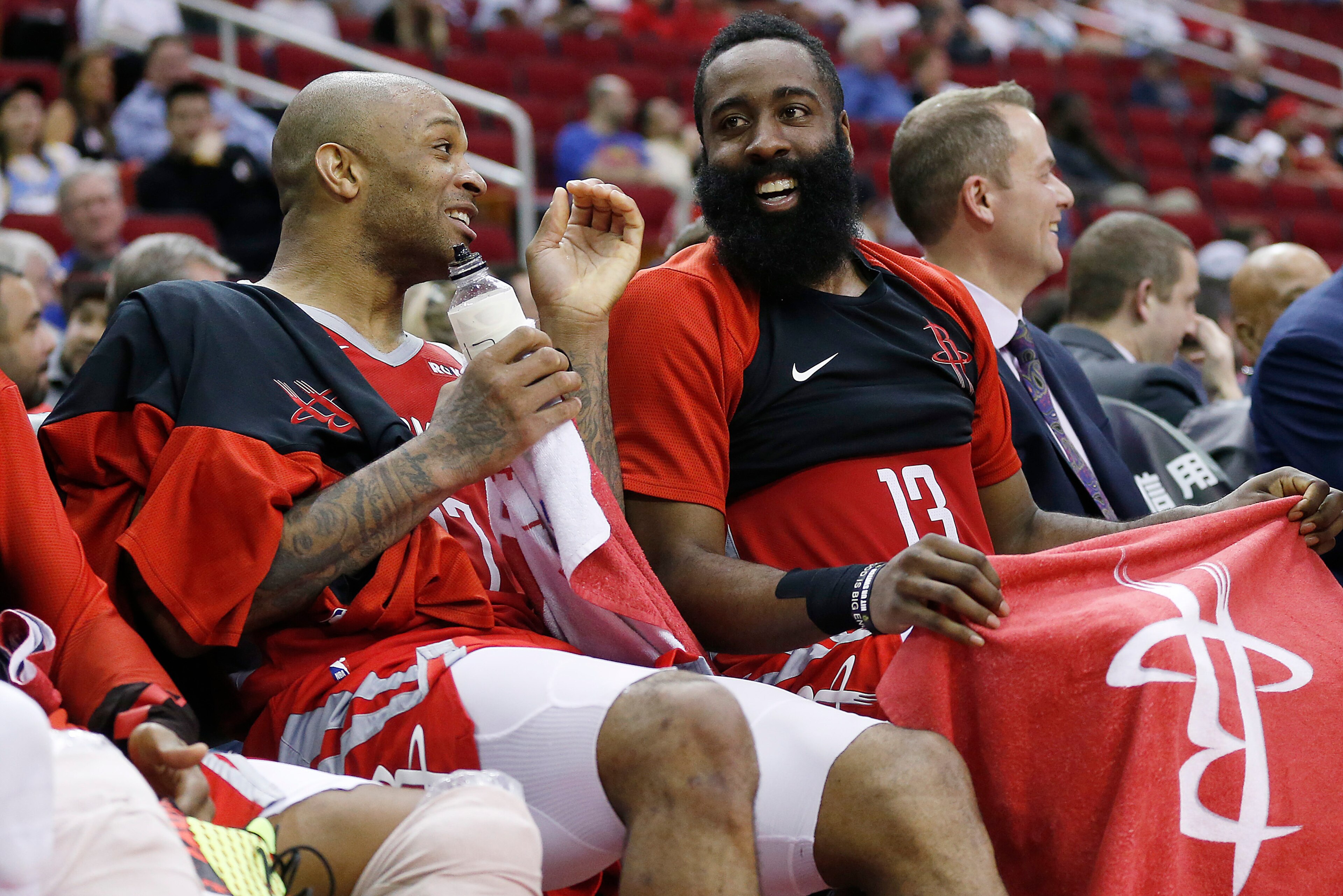HOUSTON, TEXAS - MARCH 28: PJ Tucker #17 of the Houston Rockets (L) and James Harden #13 share a laugh on the bench during a game against the Denver Nuggets at Toyota Center on March 28, 2019 in Houston, Texas. NOTE TO USER: User expressly acknowledges an