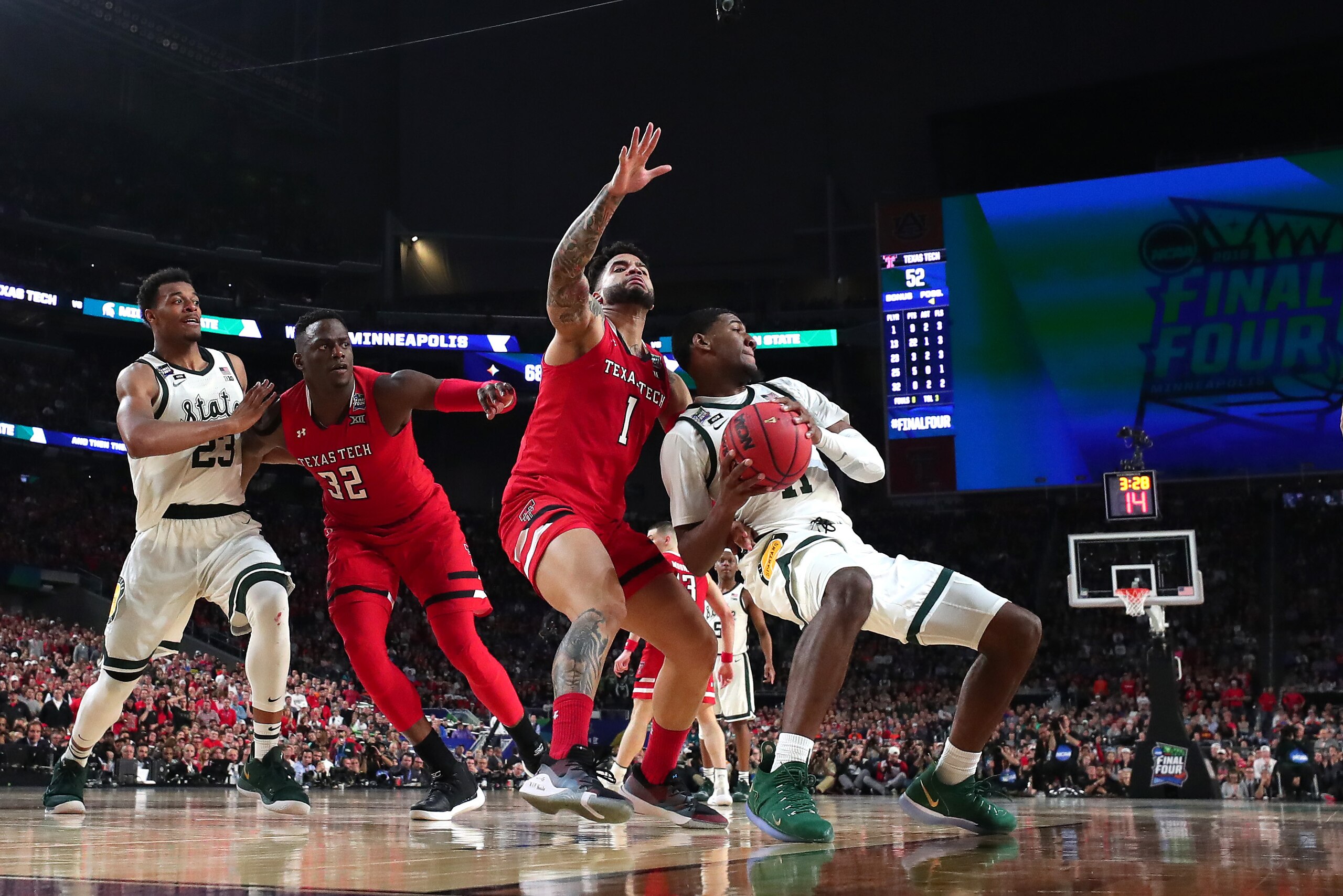 MINNEAPOLIS, MINNESOTA - APRIL 06: Aaron Henry #11 of the Michigan State Spartans battles for the ball with Brandone Francis #1 of the Texas Tech Red Raiders in the second half during the 2019 NCAA Final Four semifinal at U.S. Bank Stadium on April 6, 201