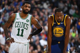 OAKLAND, CA - MARCH 5: Kyrie Irving #11 of the Boston Celtics and Kevin Durant #35 of the Golden State Warriors looks on during the game on March 5, 2019 at ORACLE Arena in Oakland, California. NOTE TO USER: User expressly acknowledges and agrees that, by