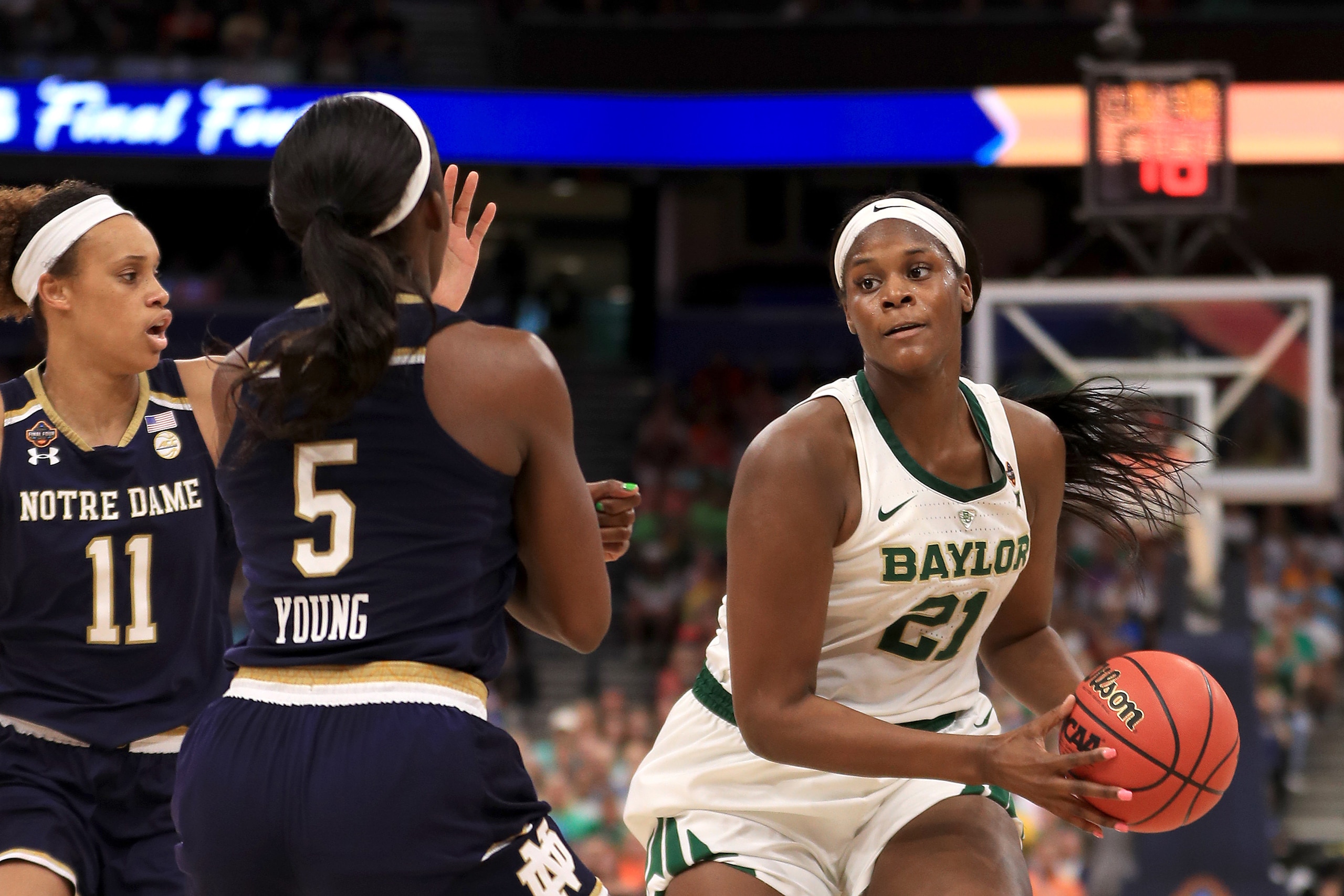 TAMPA, FLORIDA - APRIL 07:  Kalani Brown #21 of the Baylor Lady Bears is defended by Jackie Young #5 of the Notre Dame Fighting Irish during the third quarter in the championship game of the 2019 NCAA Women's Final Four at Amalie Arena on April 07, 2019 i