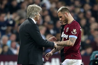 West Ham United's Chilean manager Manuel Pellegrini (L) gestures as West Ham United's Austrian midfielder Marko Arnautovic (R) is substituted during the English Premier League football match between West Ham United and Everton at The London Stadium, in ea