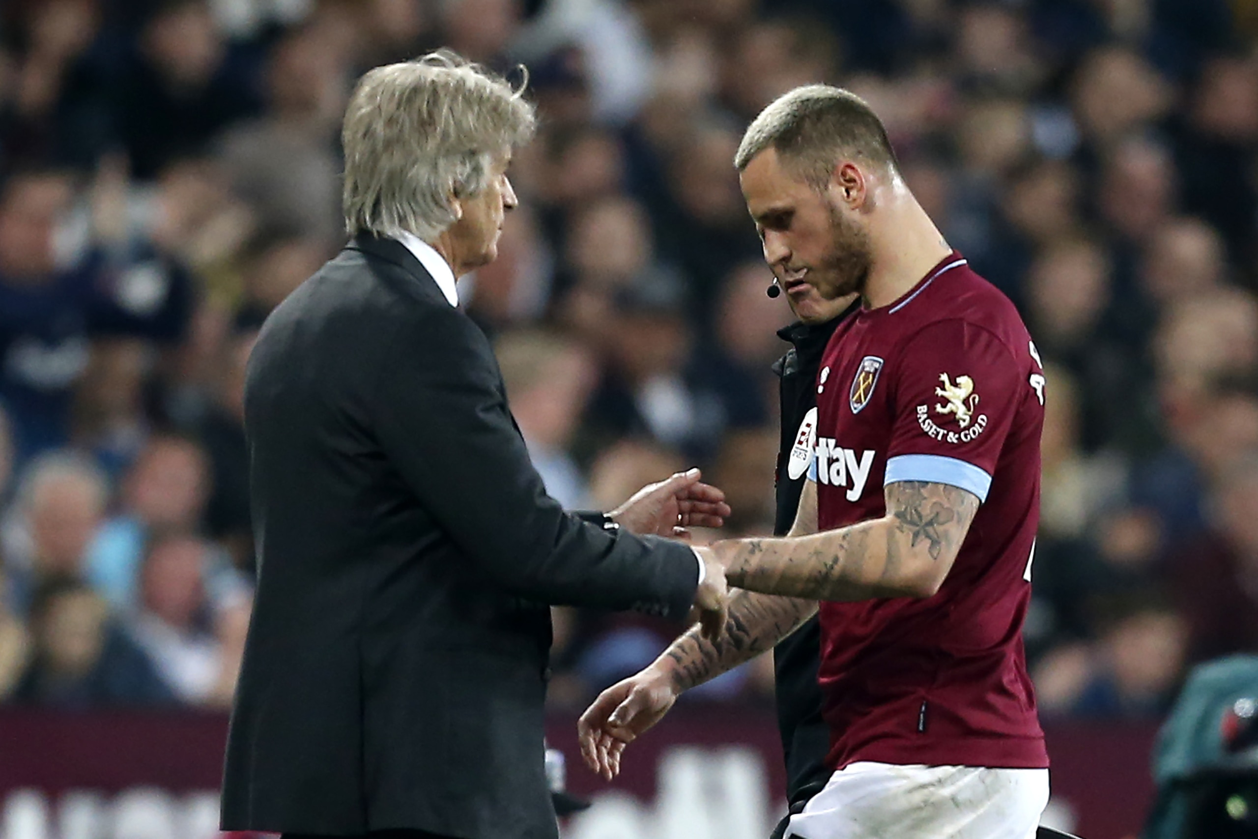 West Ham United's Chilean manager Manuel Pellegrini (L) gestures as West Ham United's Austrian midfielder Marko Arnautovic (R) is substituted during the English Premier League football match between West Ham United and Everton at The London Stadium, in ea