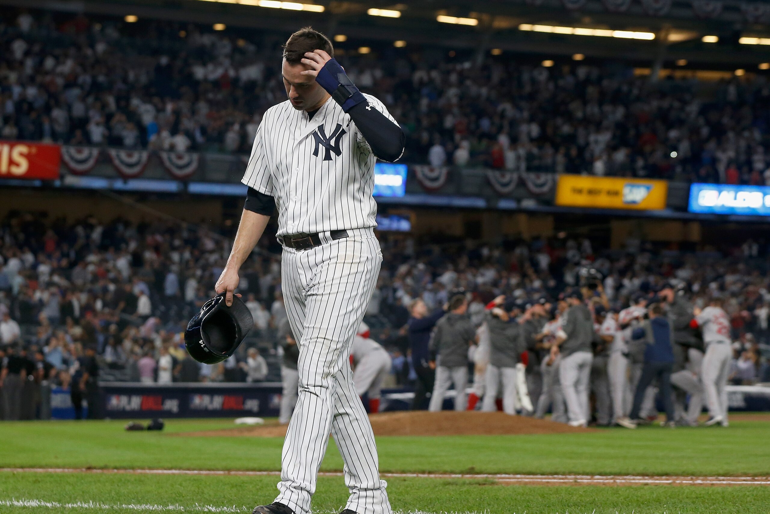 NEW YORK, NY - OCTOBER 09: (NEW YORK DAILIES OUT) Neil Walker #14 of the New York Yankees walks off the field as the Boston Red Sox celebrate after winning Game Four of the American League Division Series at Yankee Stadium on October 9, 2018 in the Br NEW YORK, NY - OCTOBER 09: (NEW YORK DAILIES OUT) Neil Walker #14 of the New York Yankees walks off the field as the Boston Red Sox celebrate after winning Game Four of the American League Division Series at Yankee Stadium on October 9, 2018 in the Br