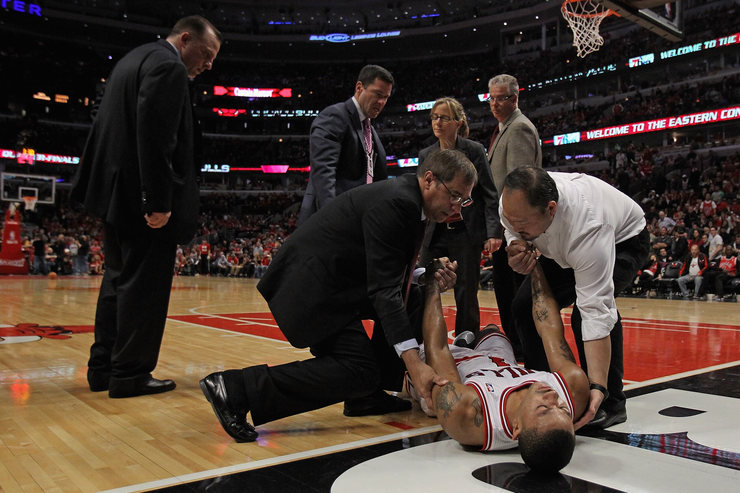 CHICAGO, IL - APRIL 28: Derrick Rose #1 of the Chicago Bulls is lifted off of the court as coach Tom Thibodeau (L) watches after suffering a knee injury against the Philadelphia 76ers in Game One of the Eastern Conference Quarterfinals during the 2012 NB CHICAGO, IL - APRIL 28: Derrick Rose #1 of the Chicago Bulls is lifted off of the court as coach Tom Thibodeau (L) watches after suffering a knee injury against the Philadelphia 76ers in Game One of the Eastern Conference Quarterfinals during the 2012 NB