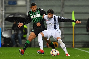 REGGIO NELL'EMILIA, ITALY - APRIL 04: Rogerio of Sassuolo competes for the ball with Medhi Leris of Chievo Verona during the Serie A match between US Sassuolo and Chievo at Mapei Stadium - Citta' del Tricolore on April 4, 2019 in Reggio nell'Emilia, Italy