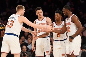 NEW YORK, NEW YORK - FEBRUARY 28: Henry Ellenson #13 of the New York Knicks high-fives teammates Kevin Knox #20, Dennis Smith Jr. #5, and Noah Vonleh #32 during the second half of the game against the Cleveland Cavaliers at Madison Square Garden on Februa