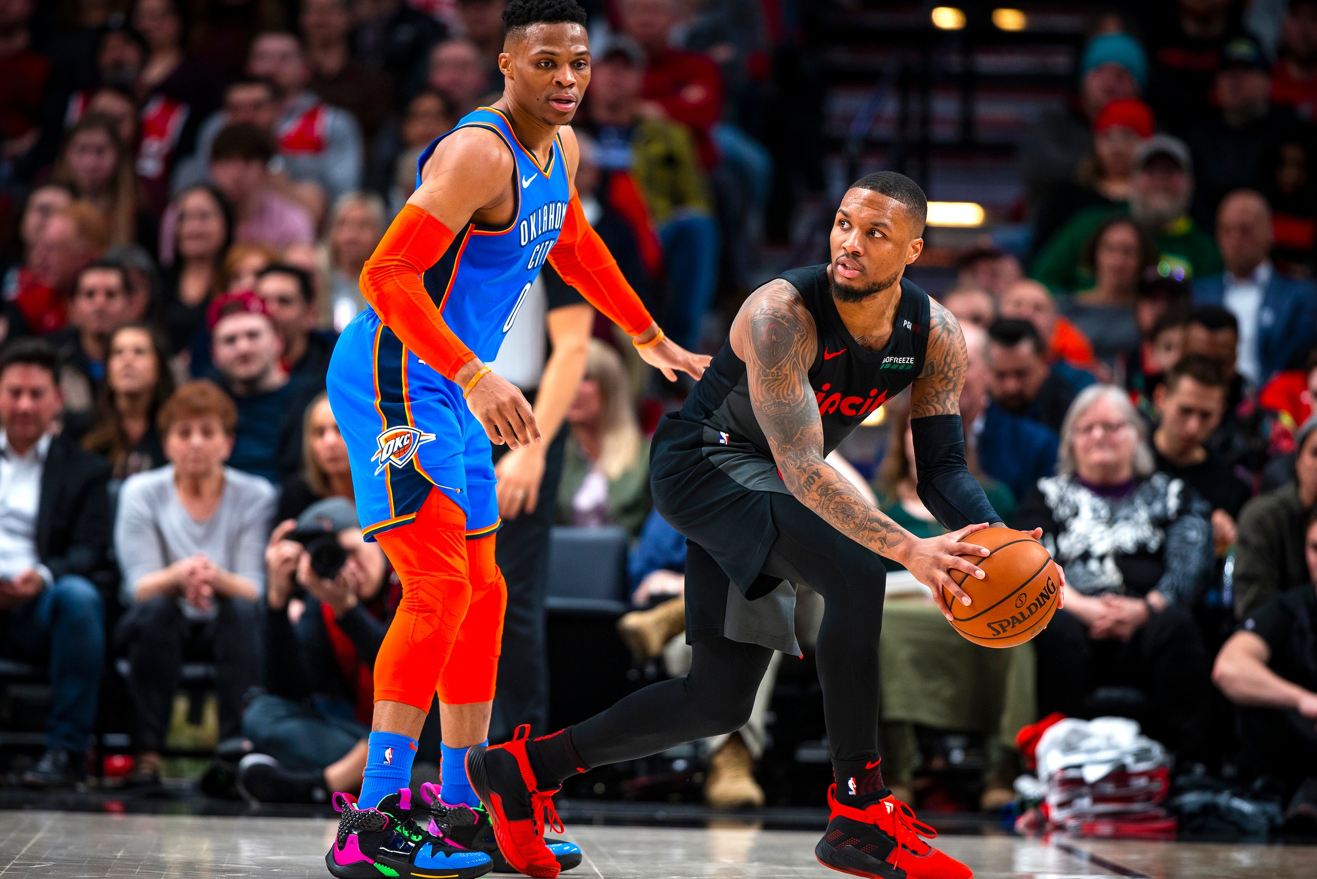 PORTLAND, OR - MARCH 7:  Damian Lillard #0 of the Portland Trail Blazers handles the ball against Russell Westbrook #0 of the Oklahoma City Thunder on March 7, 2019 at the Moda Center Arena in Portland, Oregon. NOTE TO USER: User expressly acknowledges an