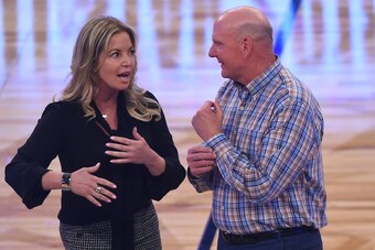 LOS ANGELES, CA - FEBRUARY 18:  Los Angeles Lakers owner Jeannie Buss and Los Angeles Clippers owner Steve Ballmer wait to hand off the ball to former NBA player and Charlotte Hornets owner Michael Jordan during the unveiling of the 2019 NBA All-Star game